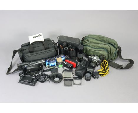 A Pentax Asahi “K1000” camera; together with four various lenses; a Samsung digital camera; a Panasonic movie camera; &amp; a