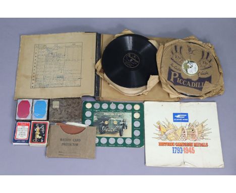 A 1950’s “Soldiers Record And Pay Book”; two vintage ration books; a “Ration card protector”; various records, etc. 