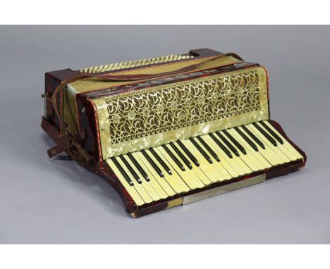 A Rosetti piano accordion, with a fibre-covered travelling case. 