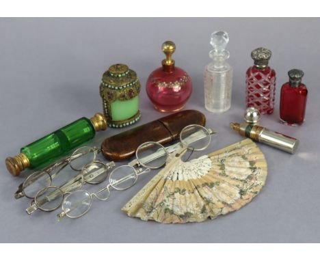 A pair of vintage silver-frame gent’s spectacles; together with three other pairs of vintage spectacles, glass scent bottles,