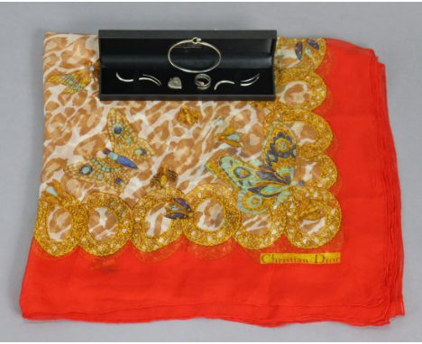 A Christian Dior silk scarf; together with a silver coiled ring, bangle &amp; earrings set; &amp; a silver heart-shaped locke