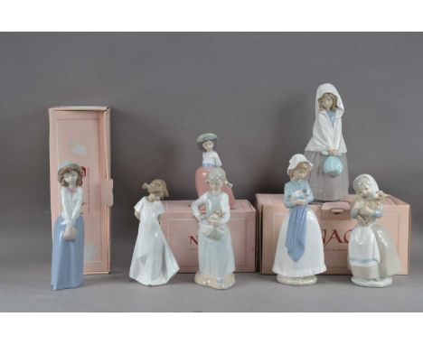 A collection of Nao porcelain figurines of girls, of differing sizes and poses, the tallest 26cm high, the shortest 16cm high