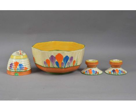 Four items of Clarice Cliff pottery, comprising a honey jar and cover, 10cm high, marked to the underside, a pair of dwarf 'c