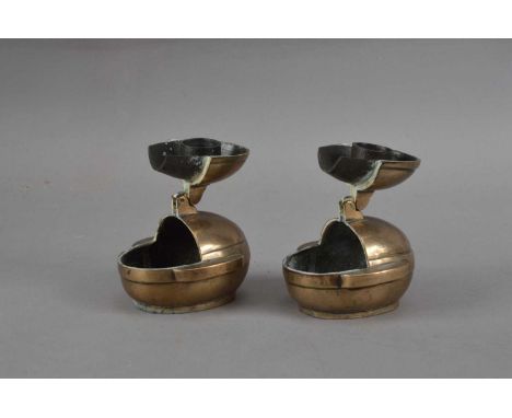 Two Chinese brass travel candlesticks, twin handled oval form, the top lifting open forming the candlestick holder, both with