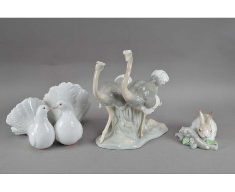 A Lladro porcelain figural group of two doves, 21cm wide, a small figurine of a rabbit (a leaf chipped AF)and a Nao figural g