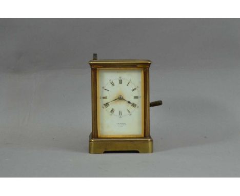 A late 19th/ early20th century brass carriage clock, Stamped 'PARIS' to the reverse of the movement, retailed by J.W. Benson 