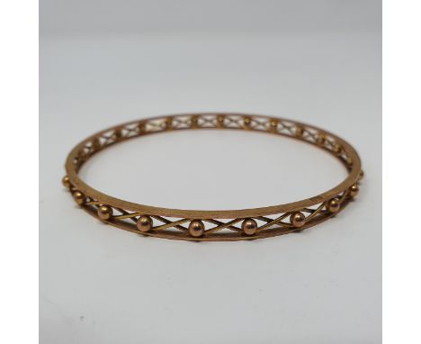 A yellow metal bangle 