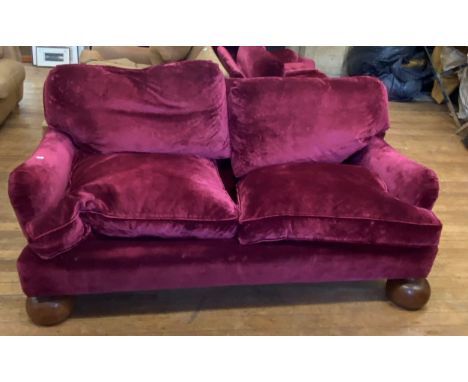 A red velvet three piece suite, a comprising sofa, and two armchairs, on large oak bun feet (3)Sofa 185 cm wide 