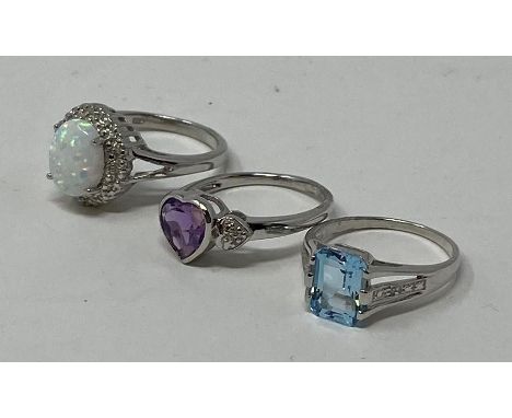 A silver, opal and diamond ring, a silver topaz ring, and a silver and amethyst ring (3)This is a modern copy 