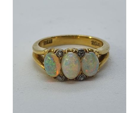 An 18ct gold, opal and diamond ring, ring size K 