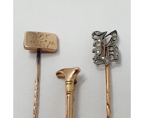 A stick pin, initialed B with diamonds, a 9 ct gold riding crop stick pin and another stick pin, the finial dated 1831 (3) 