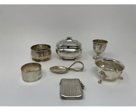 A silver mustard pot, vesta, two salts, baby's spoon, egg cup, and a napkin ring, various dates and marks, 12 ozt