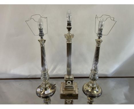 A pair of silver plated table lamp bases, in the form of Corinthian columns, 41 cm high and another, 47 cm high (3)The wire h