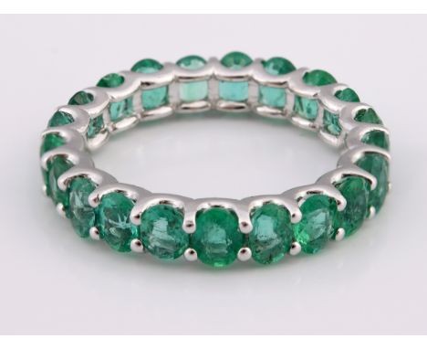 A 14ct white gold emerald full eternity ring, ring size MTotal carat weight 4.06ct approx. 