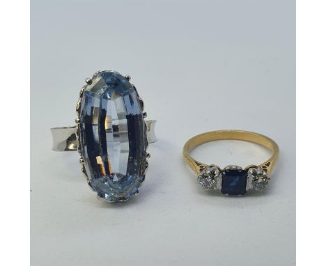 An 18ct white gold and blue stone ring, ring size L and a 18ct gold, sapphire and diamond ring, ring size L 1/2 (2) 