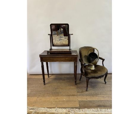 A 19th century mahogany folding card table, 86 cm wide, a mahogany bedroom mirror, two brass coal helmets, and a mahogany fra