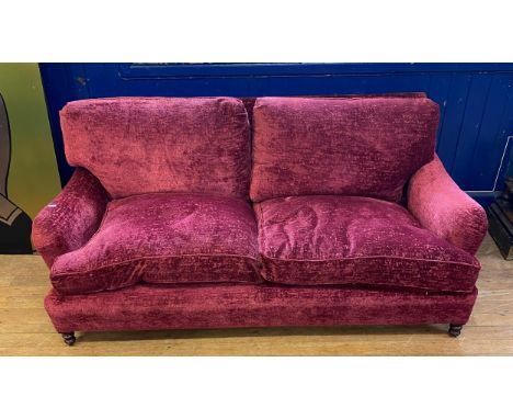 A red velvet two seater sofa, 190 cm wide 