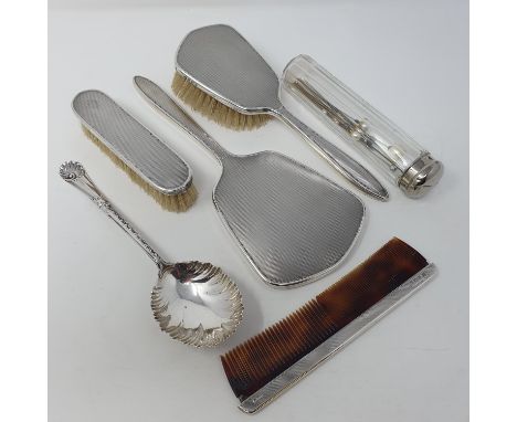 A silver hand mirror, Birmingham 1968, two matching brushes, a comb with silver mount, a serving spoon, a glass bottle with s