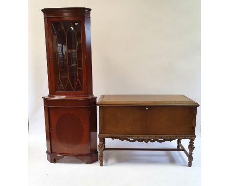 A walnut trunk on stand, 114 cm wide, a mahogany corner cabinet, and a mahogany two tier table (3) 