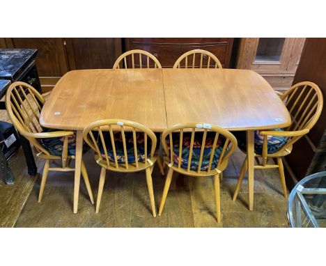 An Ercol light elm extending dining table, and six matching hoop back chairs (7)top 152 cm x 82 cm ,  light wear overall, dec