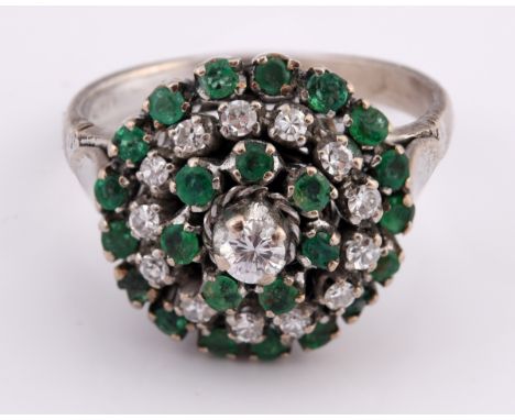 An 18ct white gold, emerald and diamond cluster ring, ring size N 1/2 