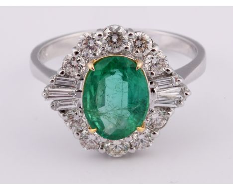 An 18ct white gold, oval cut emerald and diamond cluster ring, ring size MEmerald weight 1.41ct approx. Diamond 0.82ct approx