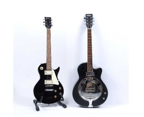 A 'Vintage' bass guitar, the ebonised body with ivorine string line decoration, 98.5cm overall; and an 'Encore' bass guitar w