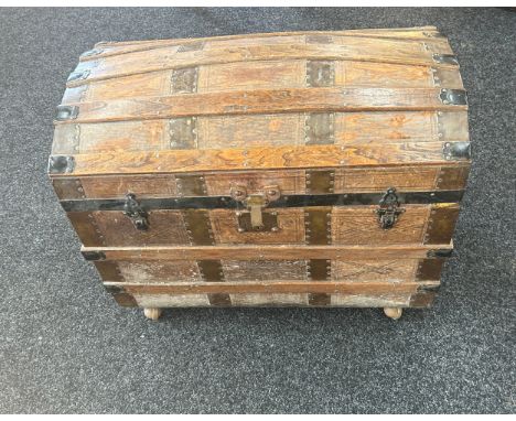Leather bound trunk on casters measures approximately 30 inches wide 18 inches depth 25 inches tall
