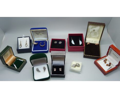 Ten pairs of silver earrings, including amber 