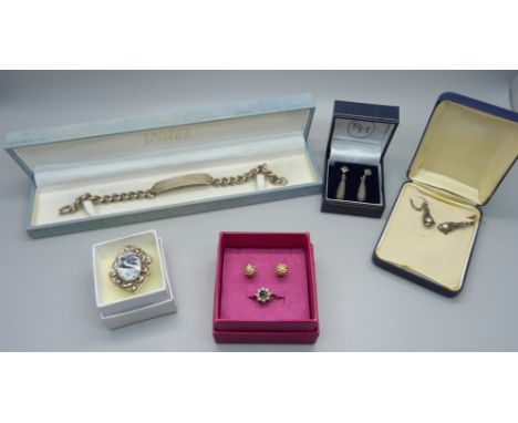 A silver ID bracelet, two silver rings and three pairs of silver earrings 
