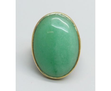 A silver gilt and jade cabochon ring, Q 