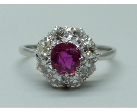 An 18ct white gold, platinum set, ruby and diamond cluster ring, shank marked 18ct and plat, 2.8g, M 