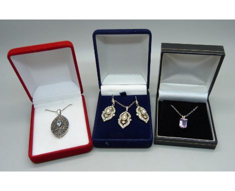 Three boxed silver pendants with chains and earrings 