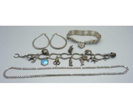 A silver horse shoe charm bracelet, a silver gate bracelet, a pair of silver earrings and a silver chain, 73g 