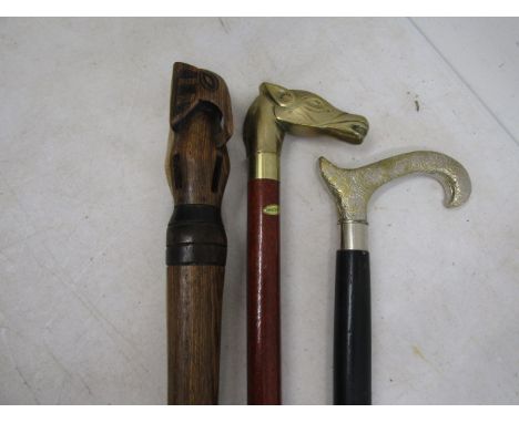 Horse head secret decanter cane, Carved elephant head cane and a metal handled cane