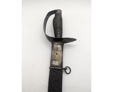 A late 19th century sword, having a white metal hilt and 63.5cm blade, along with embossed leather scabbard with white metal 