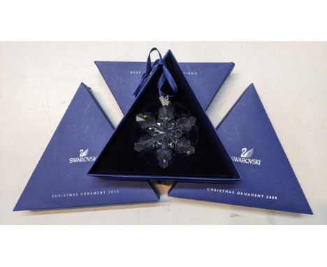 Three boxed Swarovski Christmas ornaments, 2008, 2009, and 2010