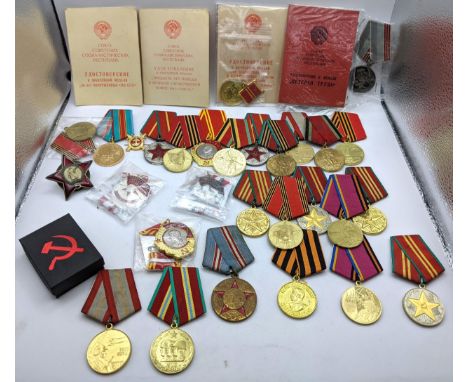 A collection of Replica USSR/CCCP medals to include Red Army WWII 50th Anniversary, Order of the Red Banner, booklets and oth