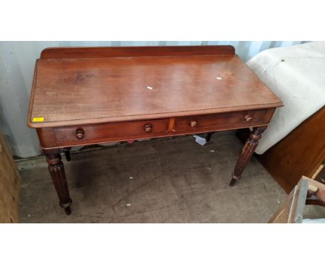 A Victorian mahogany side table having two drawers and on reeded legsLocation: 