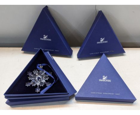 Four boxed Swarovski Christmas ornaments,&nbsp; 2004, 2005, 2007 and 1996 in a 2006 box&nbsp;