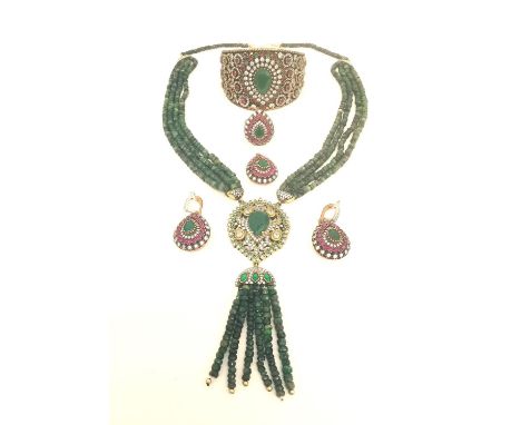 An Indian silver synthetic emerald and ruby five piece jewellery set consisting of a cuff bangle, pair of drop earrings, drop
