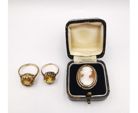 A collection of three antique yellow metal (tests as 9ct) yellow gold rings, two dress rings set with oval mixed cut Citrine'