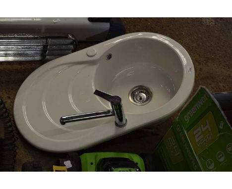 Ceramic sink together with a mixer tap
