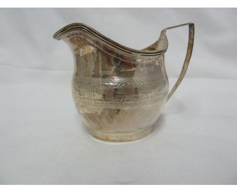 A Georgian silver helmet form cream jug, decorated with key motif bands in bright cut flanking a vacant circular reserve, Lon