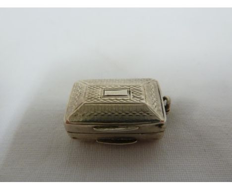 A Victorian silver miniature vinaigrette pendent, rectangular with panelled domed cover decorated with engine turning, the gi