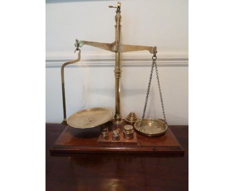 A large set of brass shop scales on mahogany fitted base and with various brass weights, marked W &amp; T Avery Ld Class B, w