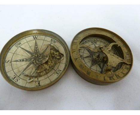 A brass pocket compass and sundial, circular with screw top cover, degrees and cardinal points printed on paper discs applied
