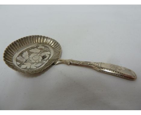 A Georgian silver caddy spoon, with pie crust rim to bowl about a bright cut flower and foliage, the handle monogrammed JB, B