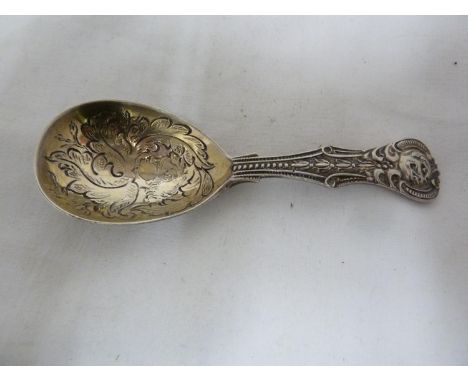 An early Victorian silver caddy spoon, ornately cast and chased with a grotesque beast handle above a bowl chased with a putt