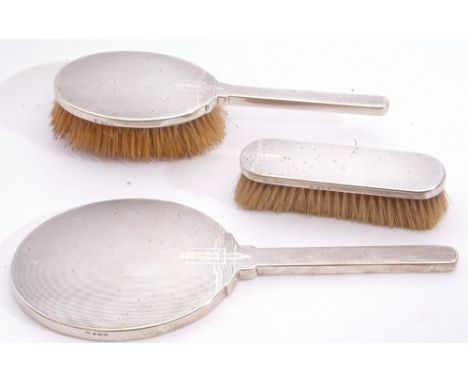 Art Deco period three piece silver mounted dressing table set with engine turned backs comprising hand mirror, hair brush and